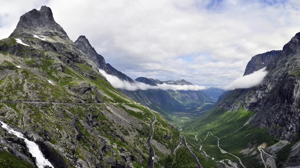 mountains valley road greenery clouds