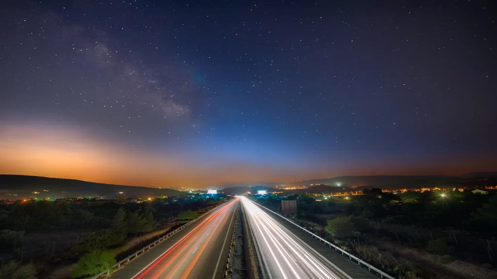 night sky stars highway lights landscape