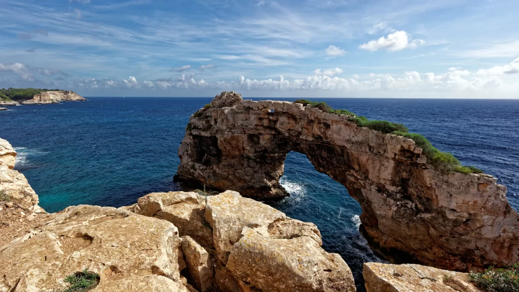 ocean rock arch blue sky