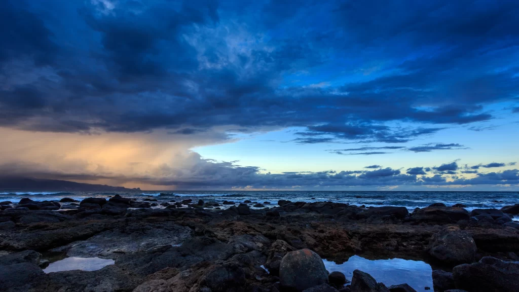 ocean rocks clouds sunset sky