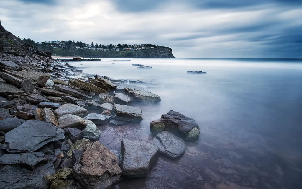 ocean rocks shore calm water