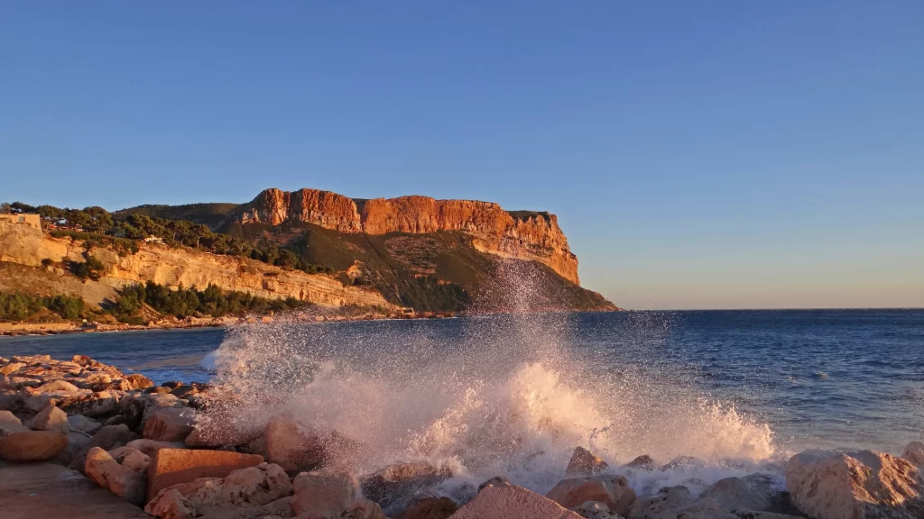 ocean waves rocks cliff sunset
