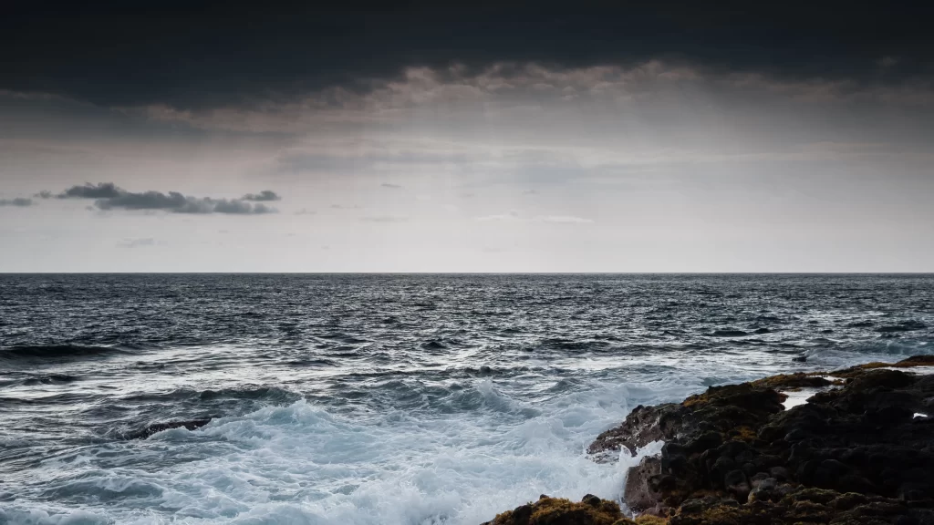 ocean waves rocky shore stormy sky