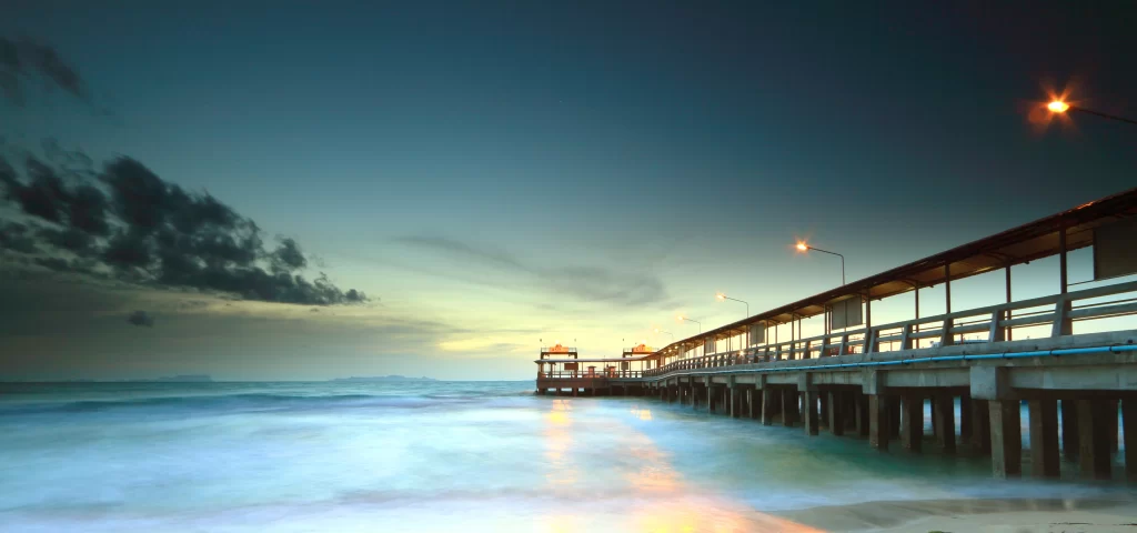pier sunset ocean clouds sky lights
