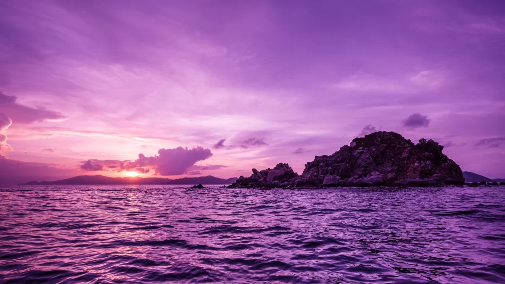 purple sunset ocean rocks serene