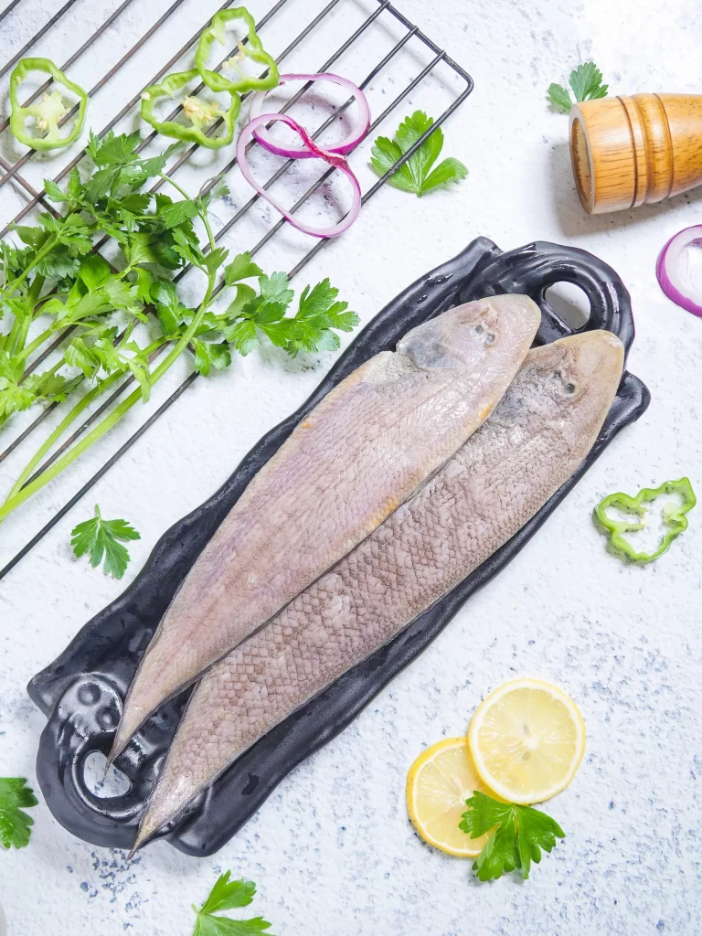 Raw Fish Whole Black Plate Green Herbs Red Onion