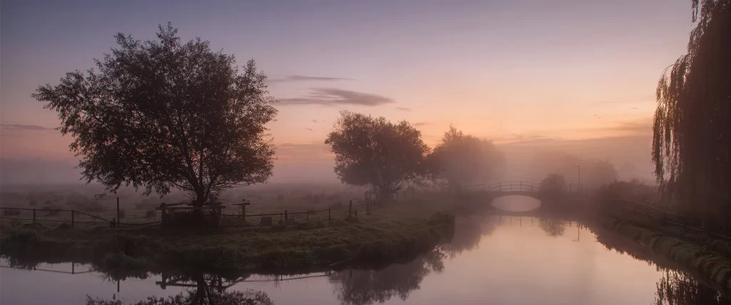 river sunrise fog trees bridge reflection