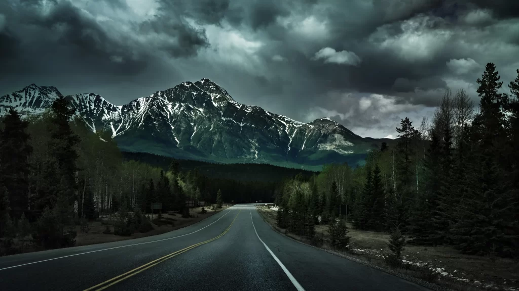 road mountain forest sky clouds