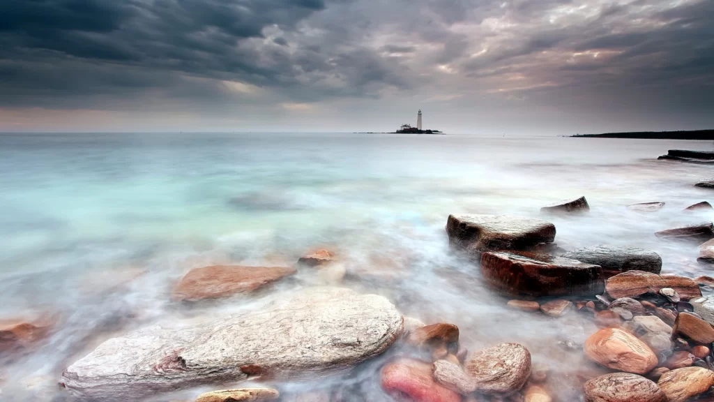 seascape lighthouse rocks water sky