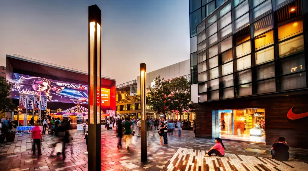 shopping mall people street lamps buildings evening leisure