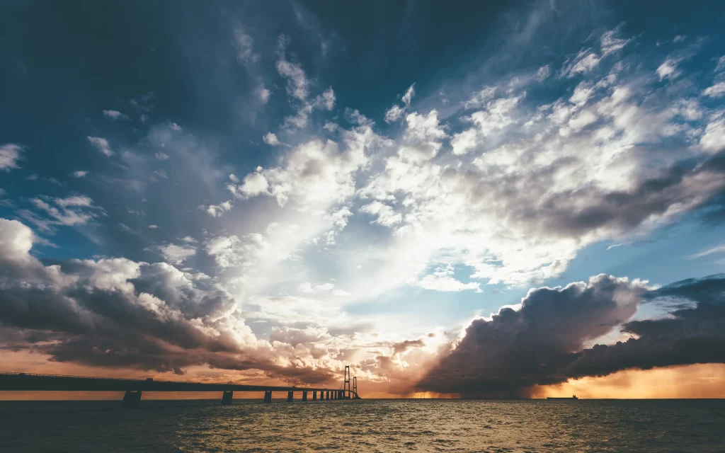 sunset clouds bridge ocean sky reflection