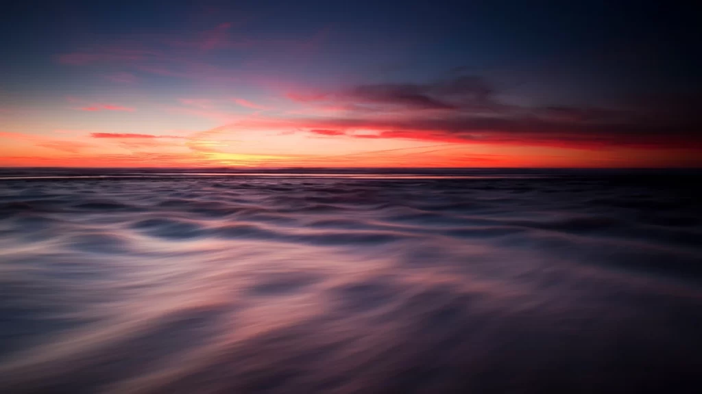 sunset ocean horizon clouds colors serene