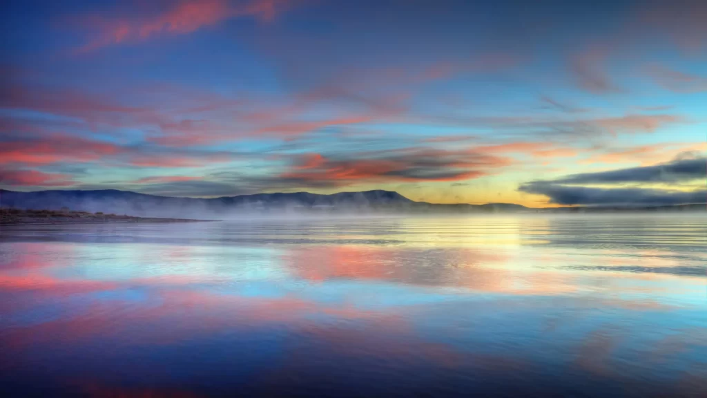 sunset reflection water sky clouds mountains