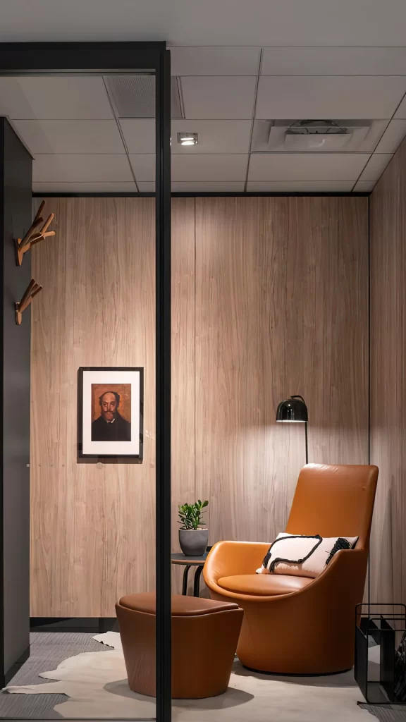 Tan Leather Armchair with Ottoman in Wood Paneled Lounge Nook