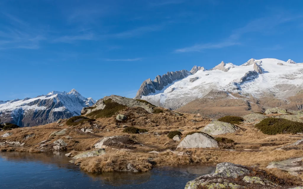 Snowy Peaks Clear Sky Rocky Terrain Tranquil Lake