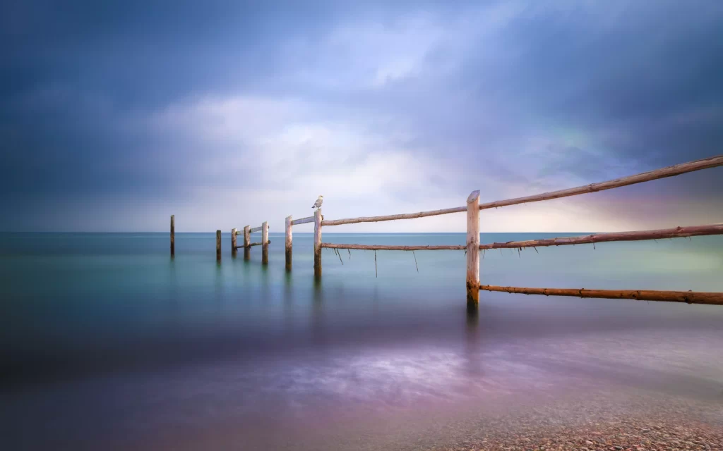 Calm Sea Wooden Fence Cloudy Sky Tranquil