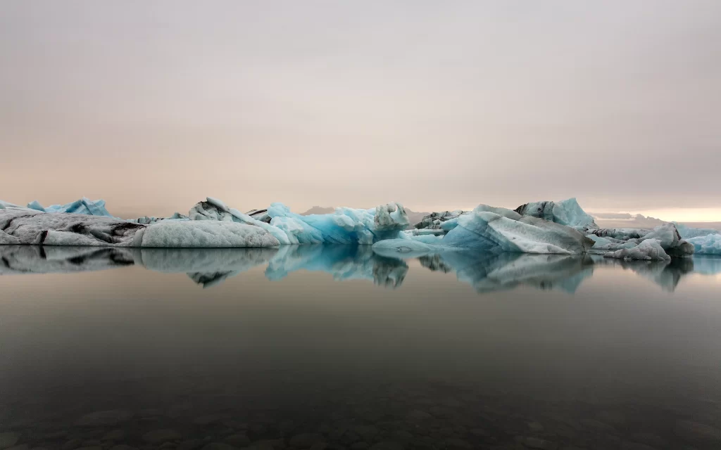 Icebergs Calm Water Reflections Misty Sky