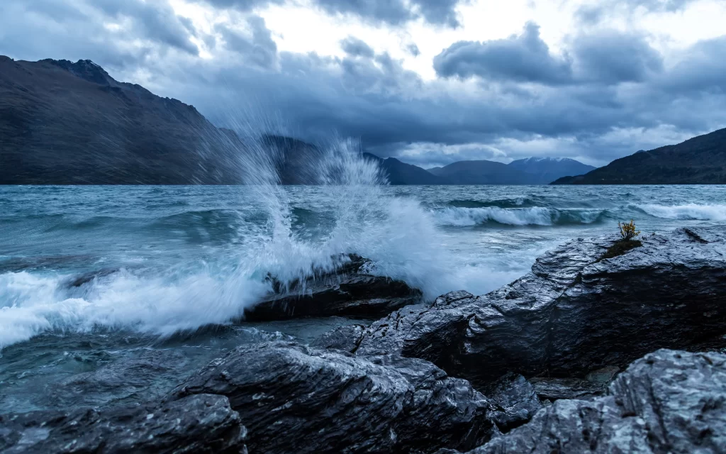 Stormy Sea Rocky Shore Mountain Peaks Cloudy Sky