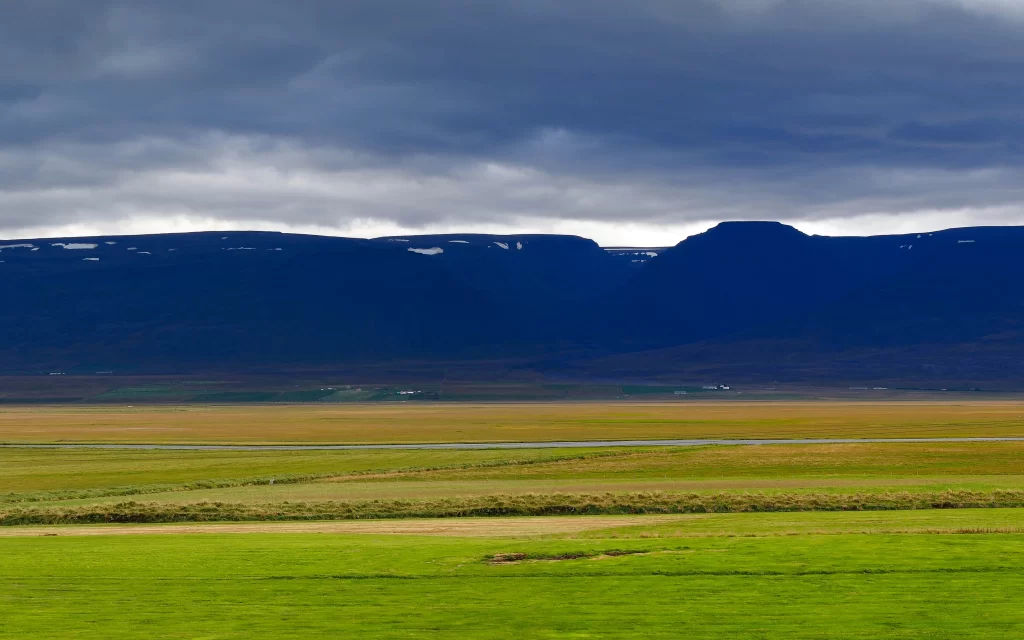 Lush Green Field Rolling Hills Cloudy Sky
