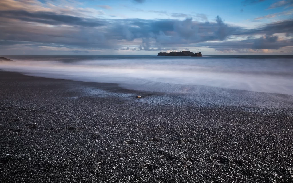 Cloudy Sky Ocean Waves Rocky Shoreline Dark Pebbles