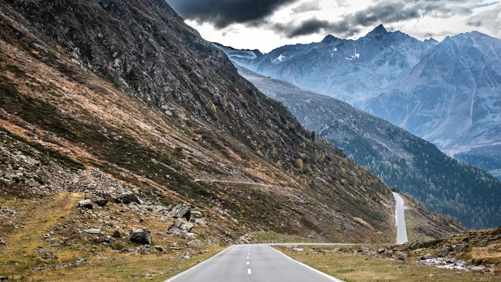 Mountainous Road Scenic Landscape Rocky Terrain Cloudy Sky