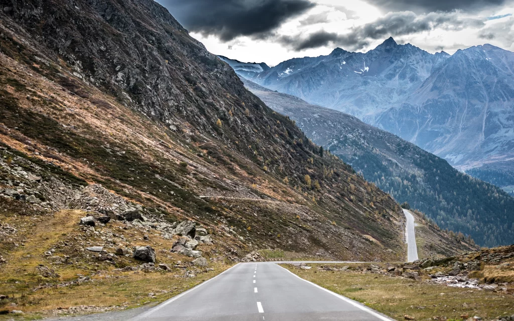 Mountainous Road Scenic Landscape Rocky Terrain Cloudy Sky
