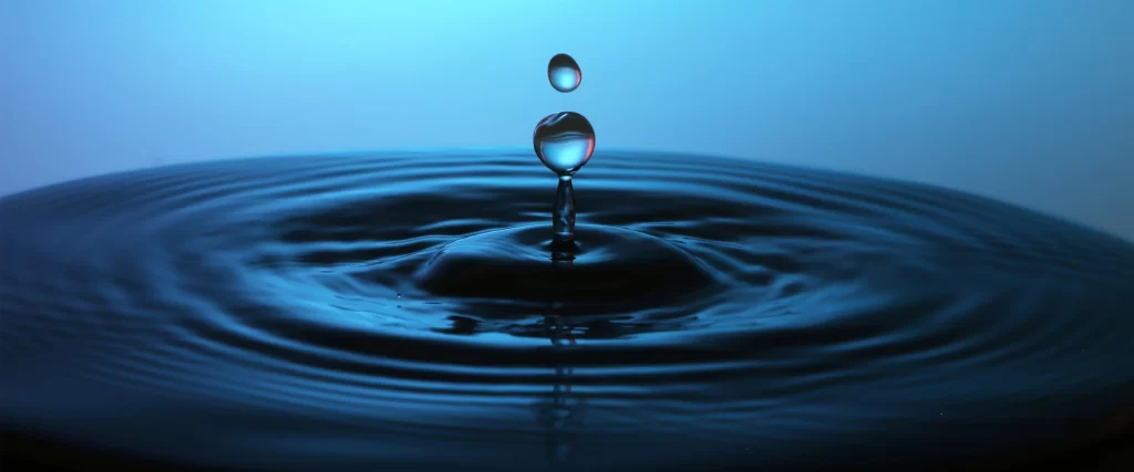 water droplet ripple reflection calm blue