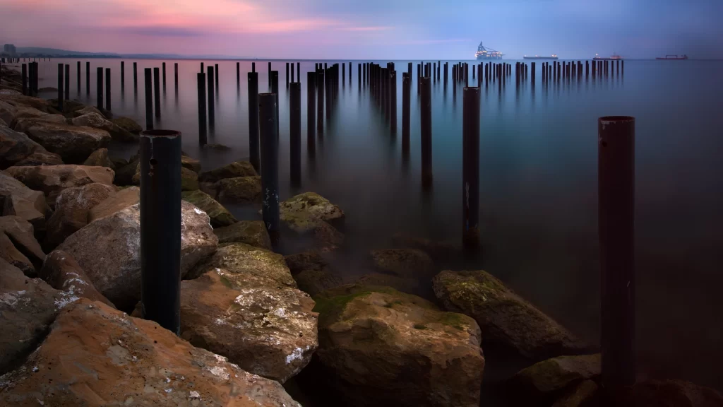 water sunset rocks pier sky reflection