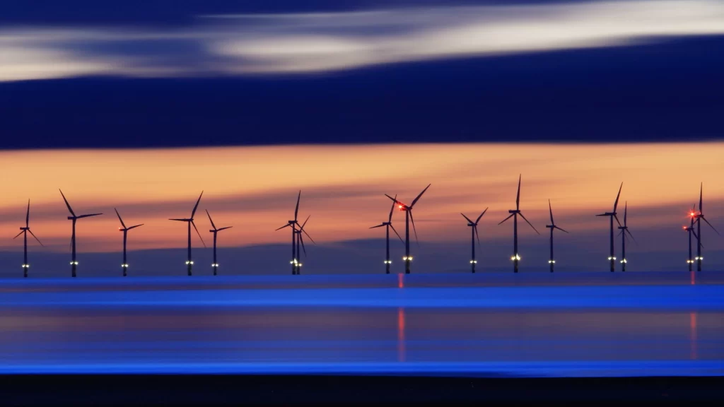 wind turbines sunset ocean reflection long exposure renewable energy