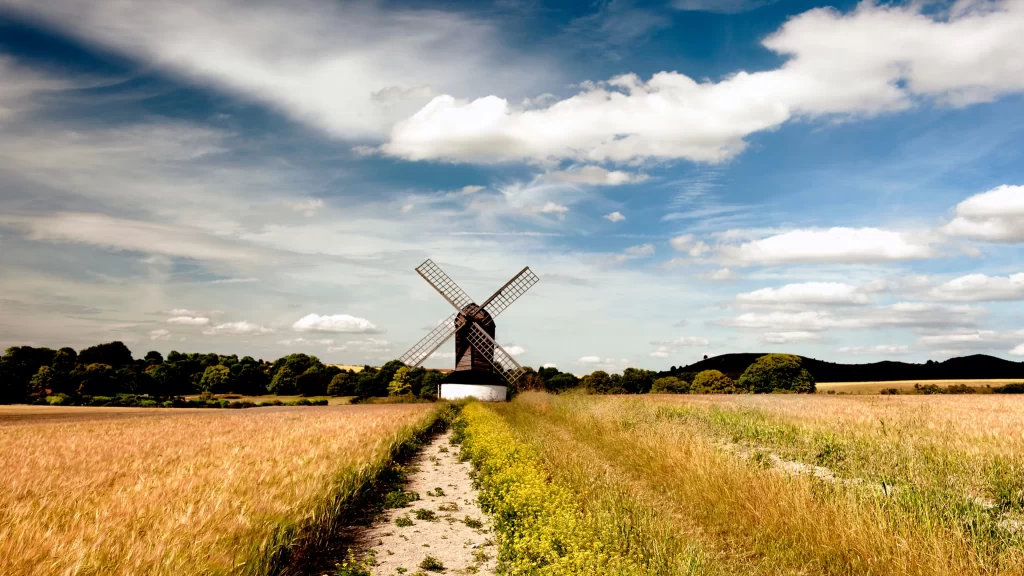 windmill field path sky clouds