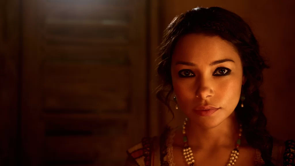 woman necklace earrings traditional attire warm lighting indoor