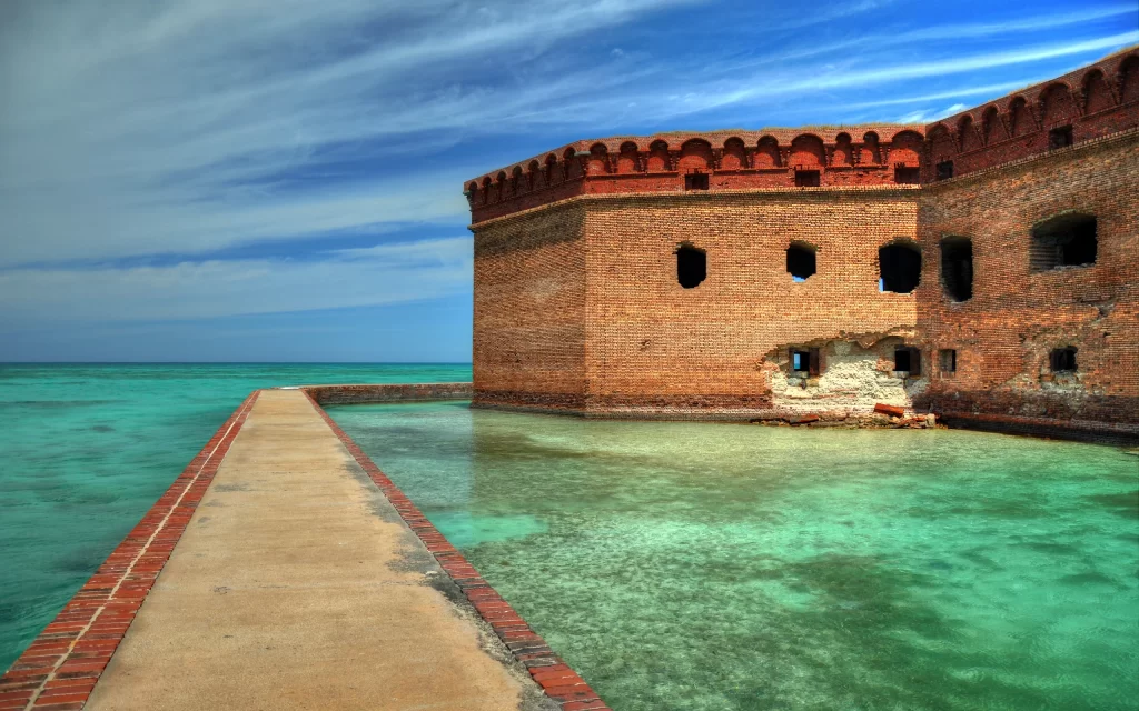 Historic Fortification Brick Structure Ocean View Coral Reef Clear Sky Blue Waters