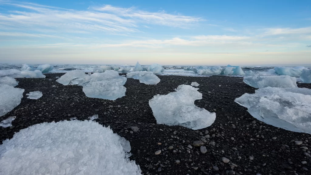 Icebergs Black Sand Beach Ocean Blue Sky Clouds