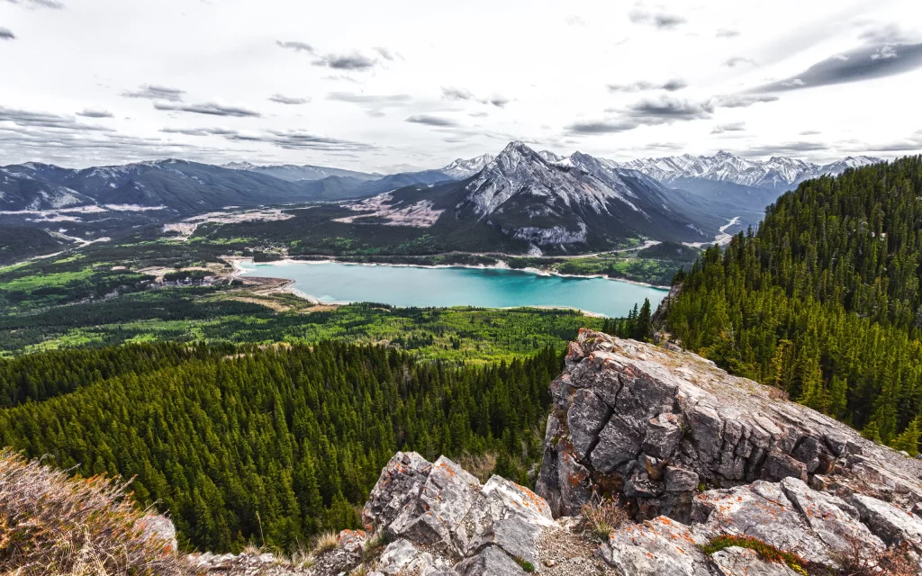 Mountainous Landscape Turquoise Lake Forest Rocky Outcrop Overcast Sky Scenic View