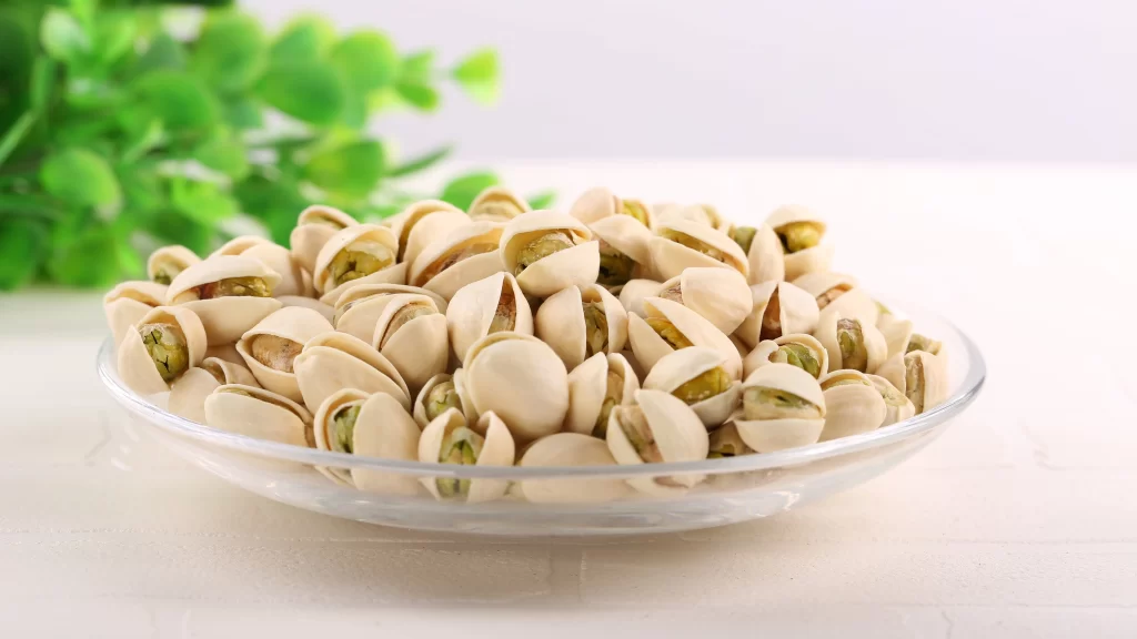 Pistachios Glass Bowl Green Plant White Surface