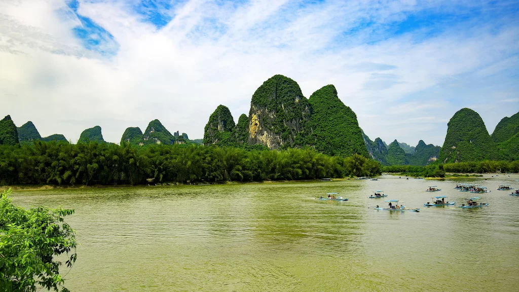 River Greenery Mountains Boats Blue Sky