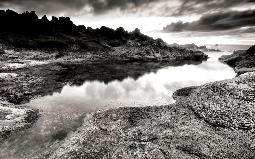 Rocky Shoreline Cloudy Sky Reflection Water Nature