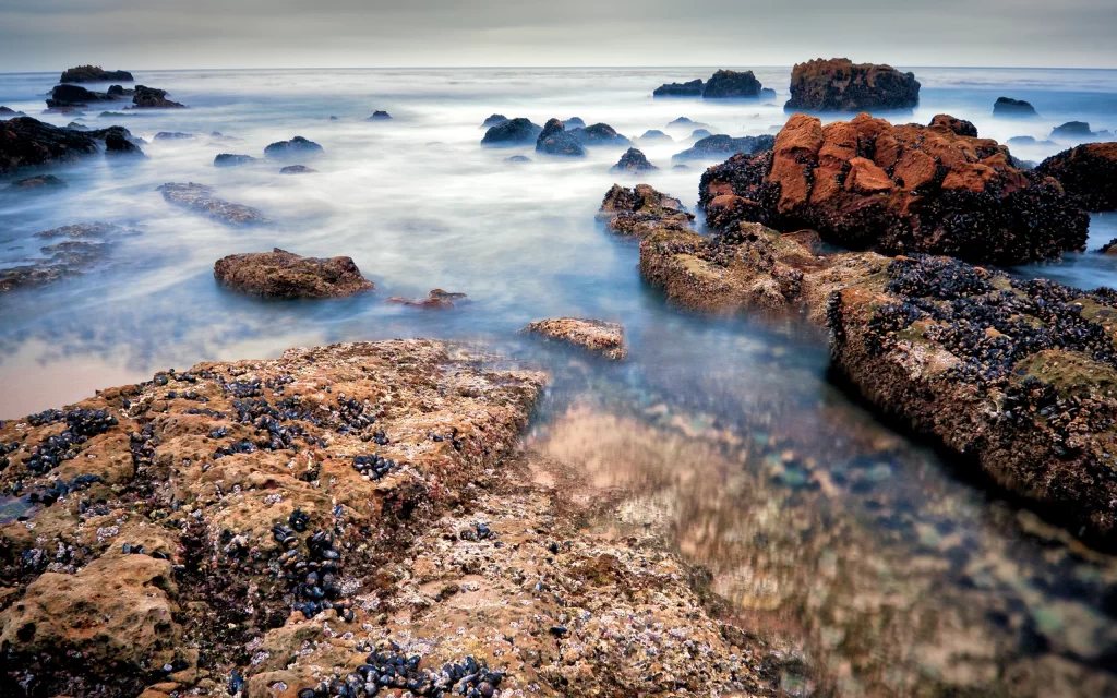 Rocky Shoreline Ocean Waves Misty Blue Sky Nature