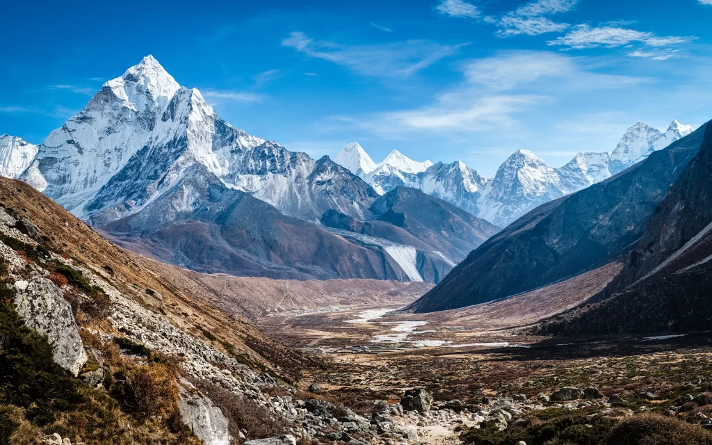 Snowy Peaks Majestic Mountains Clear Sky Glacial Valley Rocky Terrain