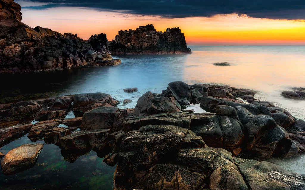 Sunset Rocky Shoreline Calm Waters Sky Clouds