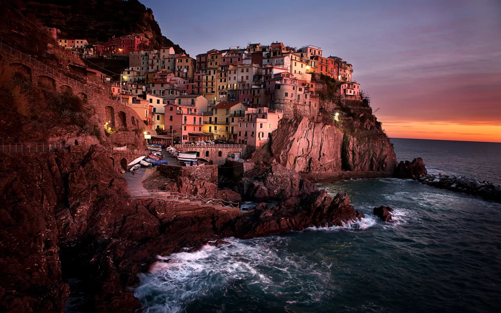 Sunset Village Cliffside Houses Ocean Waves Rocky Shore