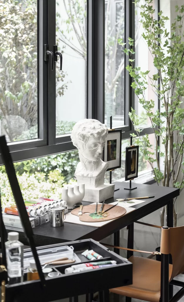 Artistic Workspace Black Furniture Neutral Palette Natural Light Sculpture