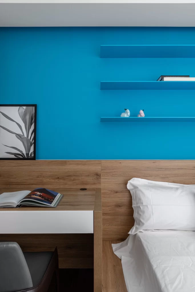 Bedroom Blue Wall Wooden Headboard White Bedding Open Bookshelf