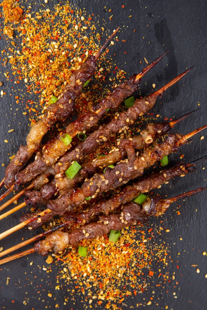 Charred Beef Skewers Sesame Seeds Green Onion Garnish