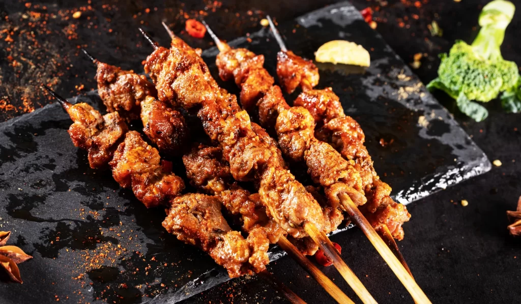 Charred Beef Skewers Spicy Sauce Golden Crust Plated