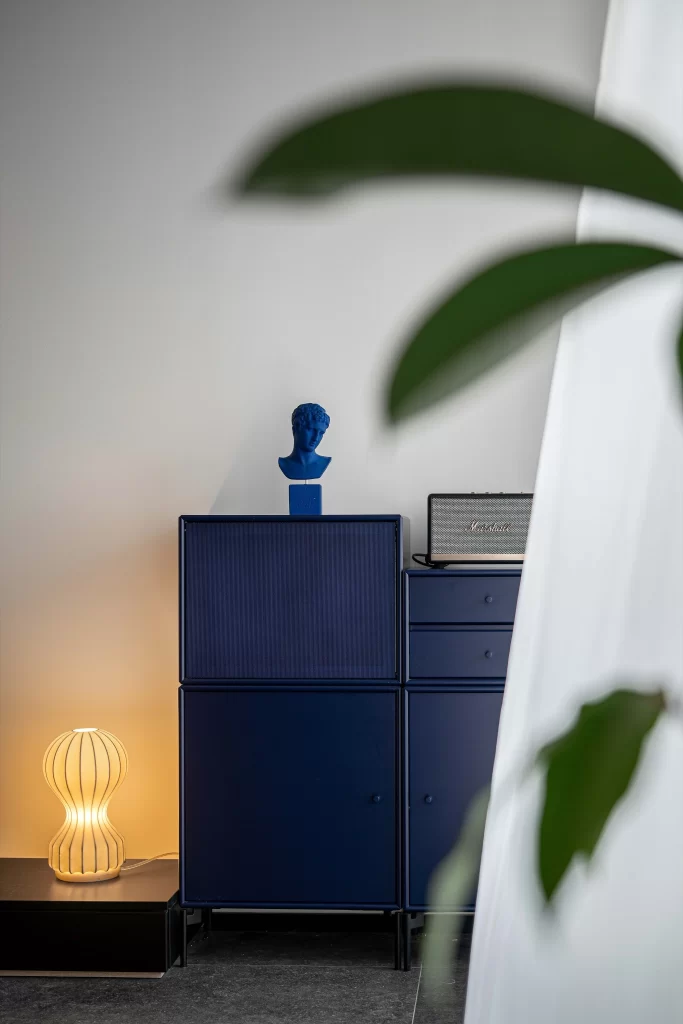 Contemporary Blue Storage Cabinet Minimalist Sculpture Warm Lighting