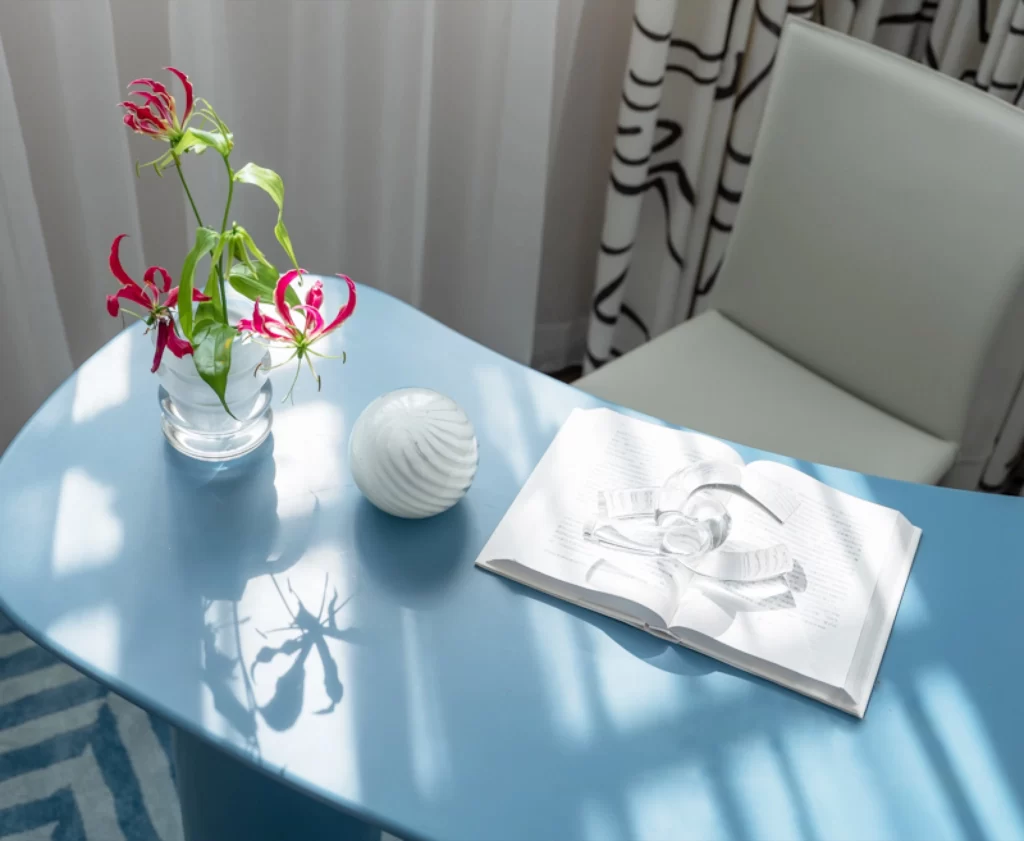 Contemporary Blue Table White Chair Patterned Curtain Natural Light