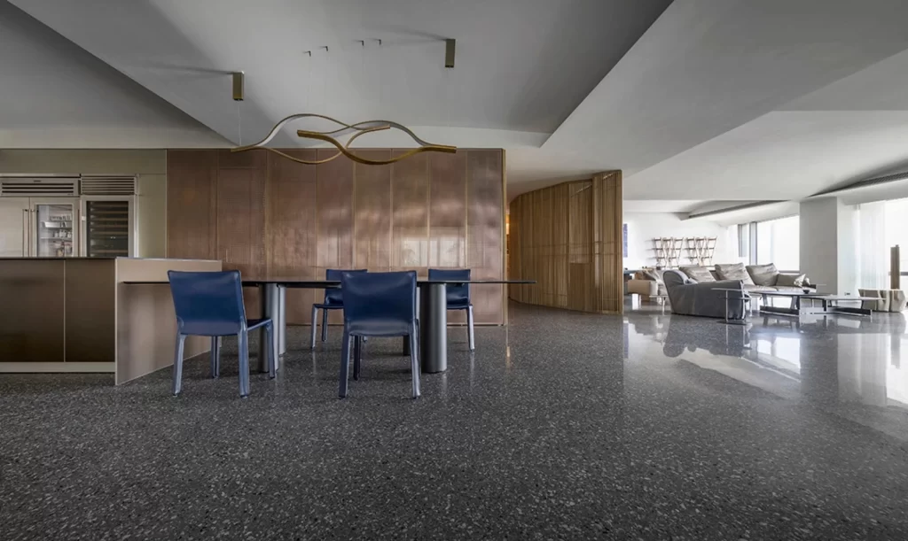 Contemporary Dining Space Neutral Tones Sleek Furniture Polished Floor Modern Lighting