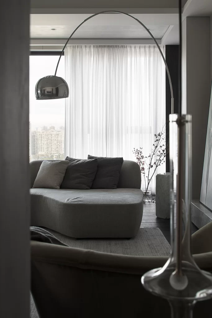 Contemporary Living Room Neutral Tones Soft Lighting Cozy Textures Patterned Accents