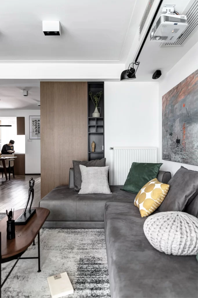 Contemporary Living Space Neutral Tones Grey Sofa Patterned Pillows Artistic Decor